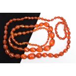 TWO SETS OF ORANGE FACETED PLASTIC BEAD NECKLACES, each designed with graduated, faceted oval beads,
