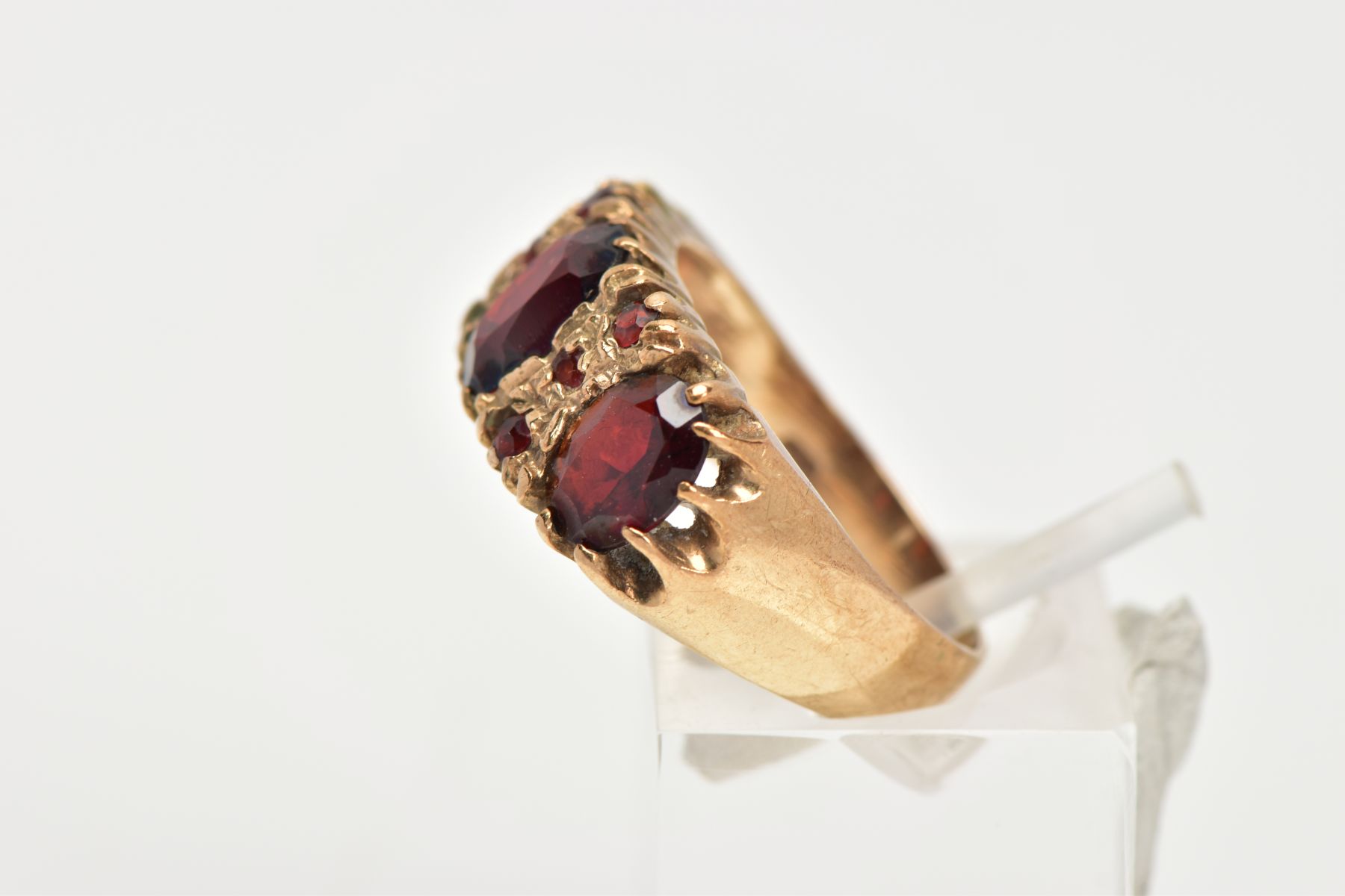 A 9CT GOLD GARNET RING, three oval cut garnets claw set in a yellow gold band with small circular - Image 2 of 4