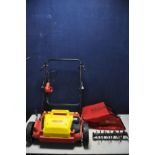 A WOLFGARTEN VS302E ELECTRIC LAWN RAKE with grass box and replacement blades (untested due to no
