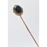 A LATE VICTORIAN MEMORIAL STICK PIN, yellow metal stick pin, with an oval sardonyx head, collet