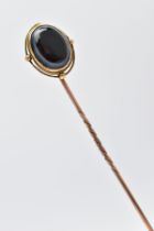 A LATE VICTORIAN MEMORIAL STICK PIN, yellow metal stick pin, with an oval sardonyx head, collet