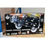 A BOXED HALSALL PLASTIC RADIO CONTROLLED LAND ROVER DEFENDER, No.TL419, not tested, without
