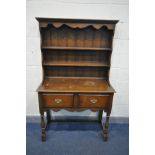 A REPRODUCTION OAK DRESSER, with two drawers, on turned front legs, width 107cm x depth 46cm x