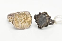 TWO EXCAVATED RINGS, two rings believed to be Roman, one ring depicting a profile, the second with a