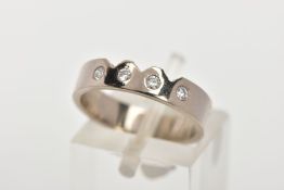 A DIAMOND SET SHAPED BAND RING, the band with three pierced dip to one front edge and flush set with