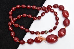 A CHERRY AMBER BAKELITE BEAD NECKLACE, graduated oval beads, largest measuring 25.4mm x 19.4mm,