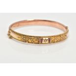 AN EARLY 20TH CENTURY GOLD BANGLE, a 9ct gold hollow hinged bangle, set with a single rose cut
