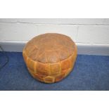 A VINTAGE LEATHER PATCHWORK POUFFE with etched panels, diameter 49cm (condition:- in good