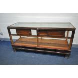 AN EARLY 20TH CENTURY HABERDASHERY CABINET with a glazed top, front and sides, four wooden sliding