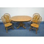 A CIRCULAR OAK PEDESTAL EXTENDING DINING TABLE with an additional leaf, diameter 106cm x open