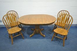 A CIRCULAR OAK PEDESTAL EXTENDING DINING TABLE with an additional leaf, diameter 106cm x open