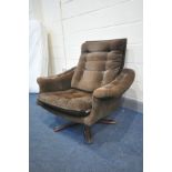 A MID CENTURY DANISH STYLE SWIVEL ARM CHAIR with what appears to be the original fabric so doesn't