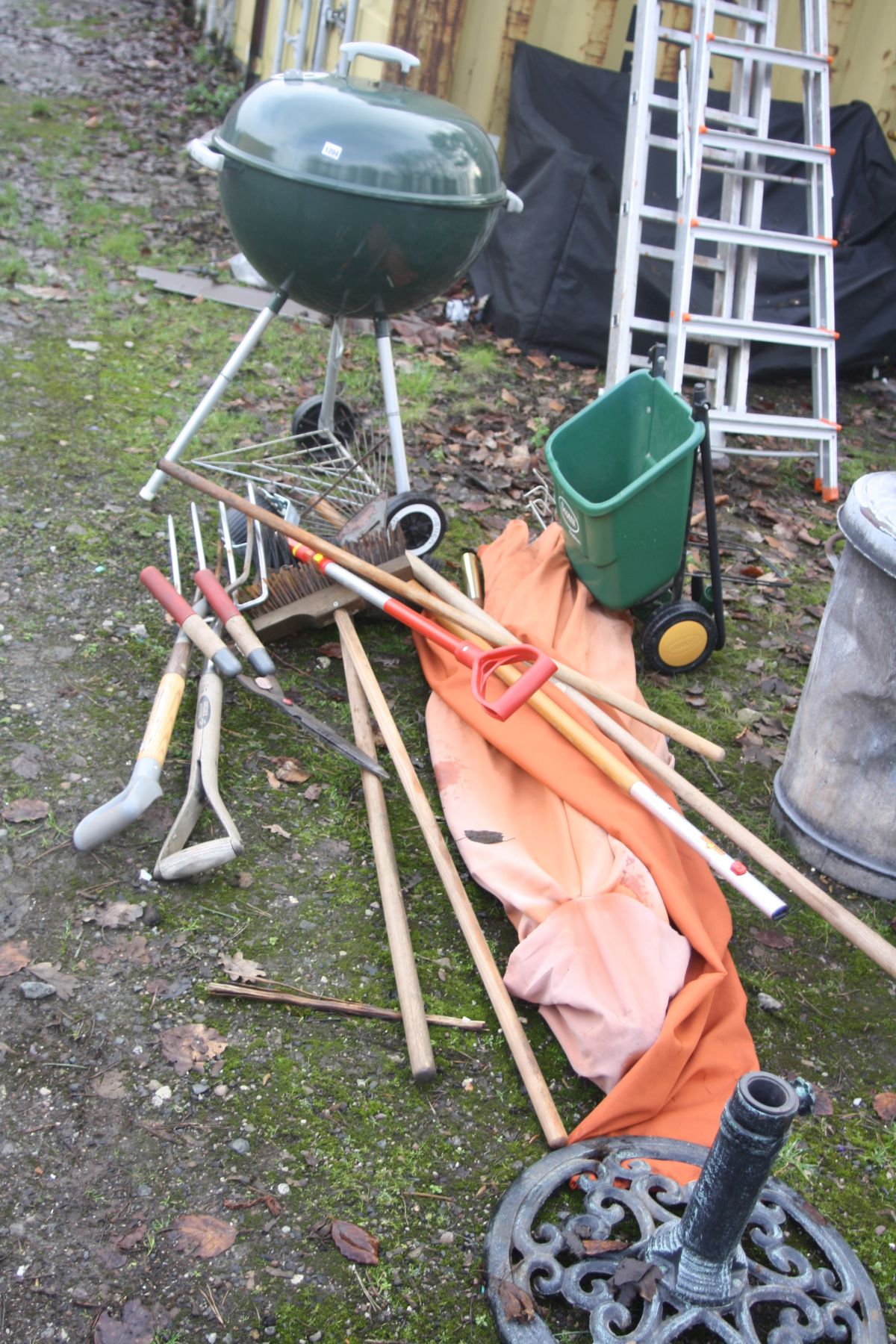 A WEBER BARBECUE, a parasol and stand along with various garden tools