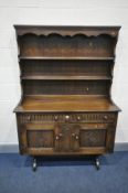 AN OAK DRESSER, with two drawers, on a trestle base, width 122cm x depth 46cm x height 176cm