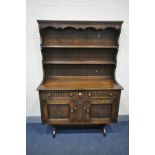 AN OAK DRESSER, with two drawers, on a trestle base, width 122cm x depth 46cm x height 176cm