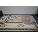 FIVE VINTAGE WOOL RUGS comprising of an hand knotted cream ground runner with red and green border