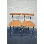 A PAIR OF MODERN BAR STOOLS with chromed tubular metal legs and tan leather seat pads and backs