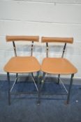 A PAIR OF MODERN BAR STOOLS with chromed tubular metal legs and tan leather seat pads and backs