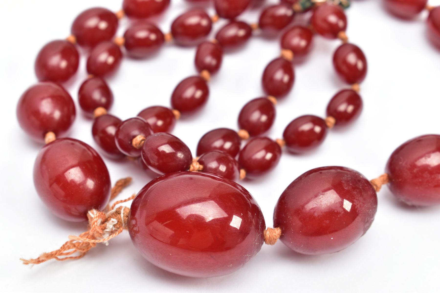 A CHERRY AMBER BAKELITE BEAD NECKLACE, graduated oval beads, largest measuring 25.4mm x 19.4mm, - Image 3 of 3