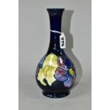 A MOORCROFT POTTERY BULBOUS SHAPED VASE DECORATED IN THE CLEMATIS PATTERN, on a dark blue ground,