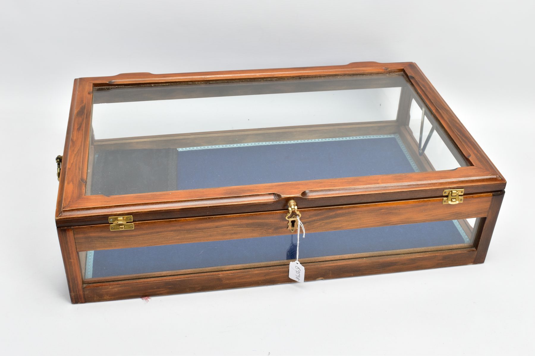 A WOODEN AND GLASS JEWELLERY DISPLAY CABINET, with a fitted blue fabric slightly tiered interior,