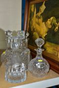 FIVE CUT CRYSTAL DECANTERS, THREE SILVER DECANTER LABELS AND A LARGE FRAMED PICTURE, comprising five