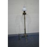 AN ART NOUVEAU TELESCOPIC BRASS OIL LAMP with shaped legs and supports, oil bowl, later glass