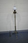 AN ART NOUVEAU TELESCOPIC BRASS OIL LAMP with shaped legs and supports, oil bowl, later glass