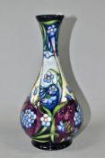 A MOORCROFT POTTERY BALUSTER VASE DESIGNED BY RACHEL BISHOP, decorated with blue flowers on a