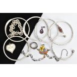 AN ASSORTMENT OF COSTUME JEWELLERY, to include a stainless steel torque bangle, detailed with