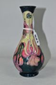 A MOORCROFT POTTERY FUSCHIA PATTERN BALUSTER VASE, a Collectors Club issue, with tubelined