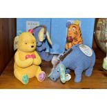 FOUR BOXED ENESCO/BORDER FINE ARTS STUDIO DISNEY CLASSIC POOH MONEY BANKS, comprising four resin,