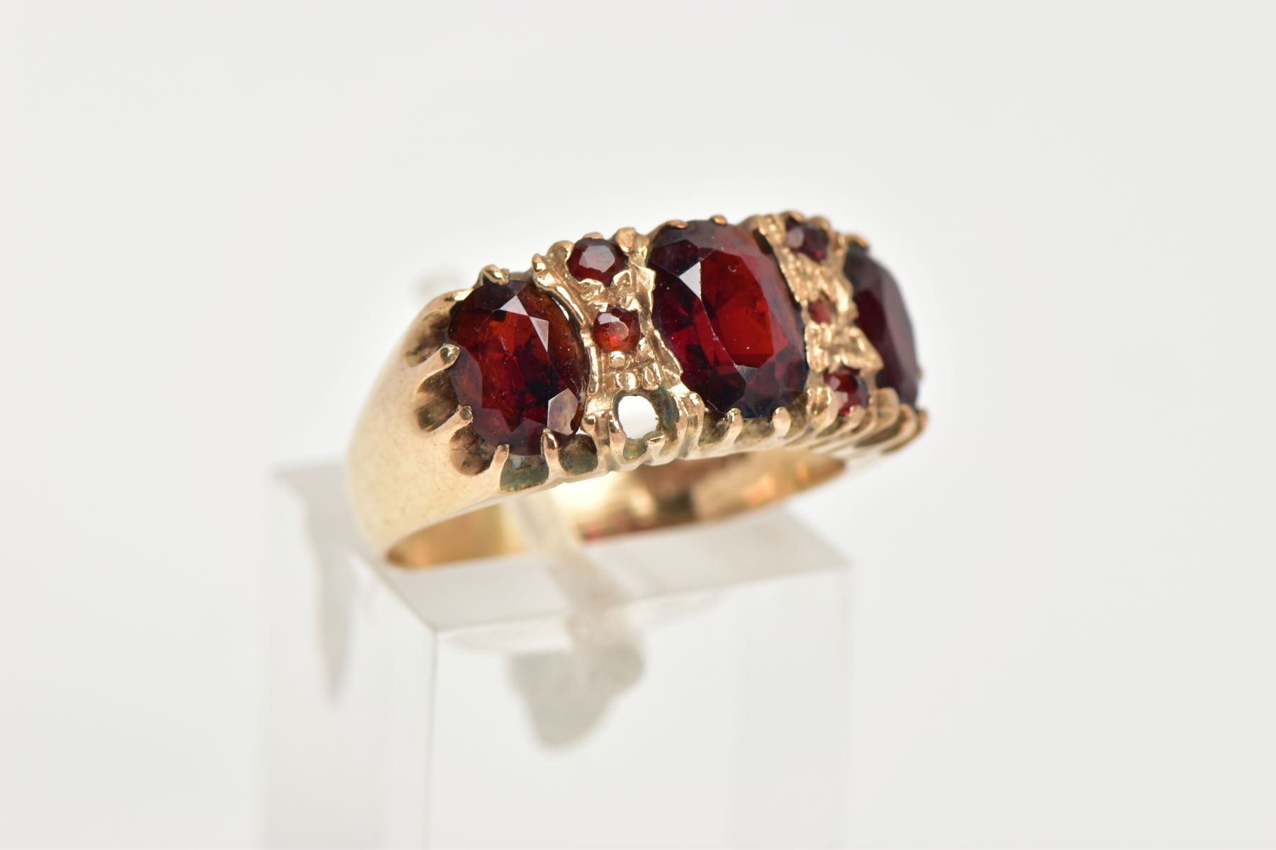 A 9CT GOLD GARNET RING, three oval cut garnets claw set in a yellow gold band with small circular - Image 4 of 4