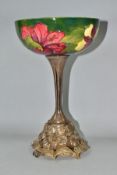 A MOORCROFT POTTERY BOWL DECORATED WITH RED AND YELLOW HIBISCUS ON A GREEN GROUND, the interior of