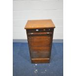 A MID CENTURY OAK ROLL FRONT CABINET with nine drawer runners (drawers missing) and lock