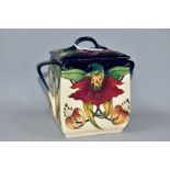 A MOORCROFT POTTERY ANNA LILY PATTERN BISCUIT BARREL, square sided barrel with lid and twin handles,