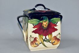 A MOORCROFT POTTERY ANNA LILY PATTERN BISCUIT BARREL, square sided barrel with lid and twin handles,