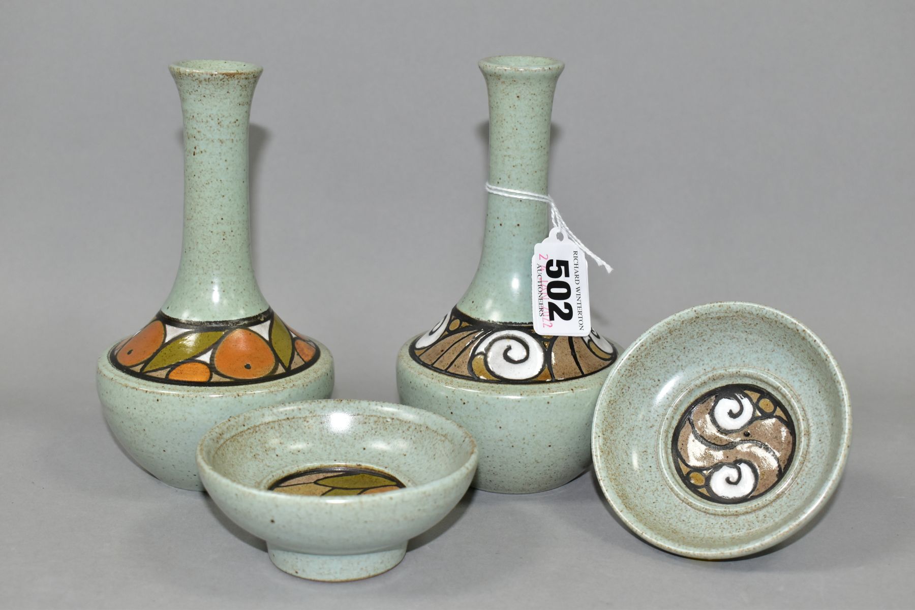 FOUR PIECES OF POOLE POTTERY, comprising two vases and two small dishes, mottled pale green ground