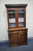 A VICTORIAN MAHOGANY BOOKCASE with two glazed door to top, ogee shaped long drawer over two cupboard