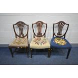 A PAIR OF GEORGIAN MAHOGANY SHIELD BACK CHAIRS and another with a drop in seat pad (repairs to leg