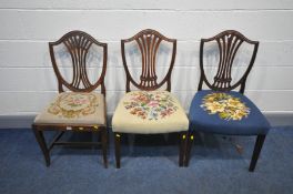 A PAIR OF GEORGIAN MAHOGANY SHIELD BACK CHAIRS and another with a drop in seat pad (repairs to leg