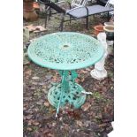 A MODERN CAST ALUMINIUM GARDEN TABLE 68cm in diameter with a pierced top and a parasol holder