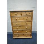 A TALL MODERN PINE CHEST OF TWO SHORT OVER FIVE LONG DRAWERS with turned feet and bun handles