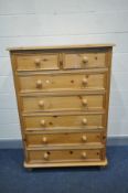 A TALL MODERN PINE CHEST OF TWO SHORT OVER FIVE LONG DRAWERS with turned feet and bun handles