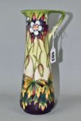 A MODERN MOORCROFT POTTERY AQUILEGIA PATTERN EWER, with tubelined Aquilegia pattern on a green,