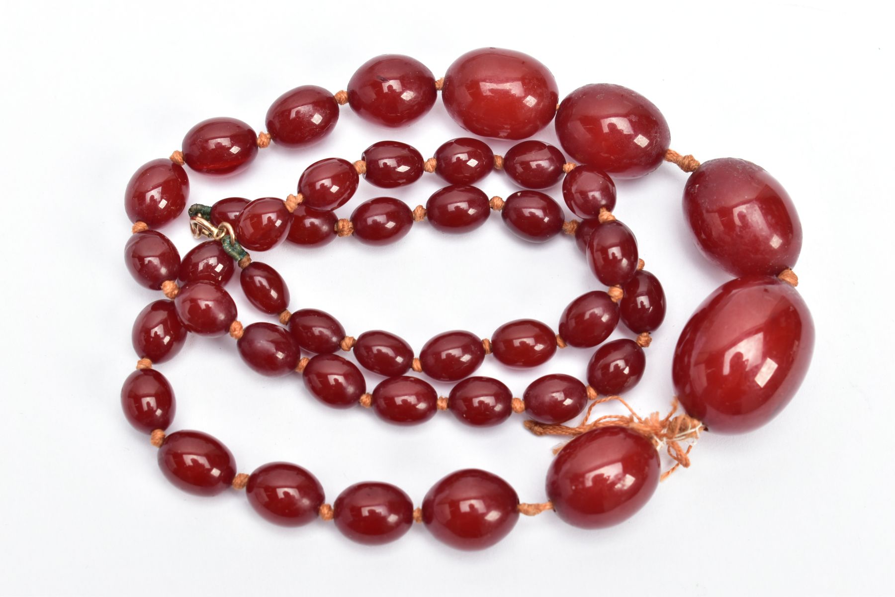 A CHERRY AMBER BAKELITE BEAD NECKLACE, graduated oval beads, largest measuring 25.4mm x 19.4mm, - Image 2 of 3