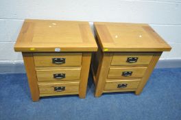 A PAIR OF SOLID GOLDEN OAK BEDSIDE CABINETS with three drawers, hoop handles, width 55cm x depth