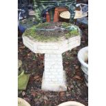 A MODERN COMPOSITE BIRD BATH with a square brickwork effect base and an octagonal top 43cm in