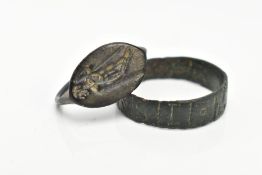 TWO EXCAVATED RINGS, two rings believed to be Roman, one ring featuring engraved lettering, the