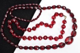 TWO SETS OF FACETED CHERRY AMBER PLASTIC BEAD NECKLACES, the first designed with circular faceted